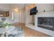 Inviting living room featuring a fireplace, hardwood floors, and access to the kitchen at 2325 Windmill Pkwy # 323, Henderson, NV 89074