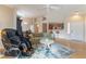 Bright living room featuring an open layout, plush seating, and modern decor and wood-look floors at 2325 Windmill Pkwy # 323, Henderson, NV 89074