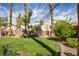 Lush backyard featuring mature trees, a well-maintained lawn, and an adorable playhouse for added outdoor fun at 2544 Sundew Ave, Henderson, NV 89052