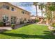 Expansive backyard offers a well-manicured lawn, barbecue grill, and a cozy dining area for outdoor entertaining at 2544 Sundew Ave, Henderson, NV 89052