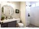 Stylish bathroom with a walk-in shower, marble countertop, and a round mirror at 2544 Sundew Ave, Henderson, NV 89052