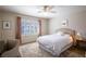 Cozy bedroom with natural light, ceiling fan, neutral walls, an upholstered headboard and a decorative rug at 2544 Sundew Ave, Henderson, NV 89052