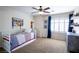 Cozy bedroom with a ceiling fan, shuttered windows, and carpet flooring at 2544 Sundew Ave, Henderson, NV 89052