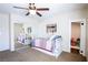 Comfortable bedroom featuring a ceiling fan, mirrored closet, and carpet flooring at 2544 Sundew Ave, Henderson, NV 89052