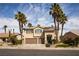 Two-story home boasts a two-car garage, desert landscaping, and tall palm trees at 2544 Sundew Ave, Henderson, NV 89052