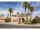 Two-story home boasts a two-car garage, desert landscaping, and mature palm trees at 2544 Sundew Ave, Henderson, NV 89052