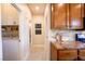 Hallway leading to the laundry room featuring tile floors and wood cabinets at 2544 Sundew Ave, Henderson, NV 89052