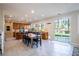 Bright kitchen with tile floors, breakfast bar, and large sliding glass doors to the yard at 2544 Sundew Ave, Henderson, NV 89052