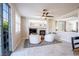Open-concept room with a fireplace, large windows, and comfortable seating at 2544 Sundew Ave, Henderson, NV 89052