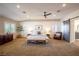 Serene main bedroom with a ceiling fan, board and batten accent wall, and comfortable seating at 2544 Sundew Ave, Henderson, NV 89052