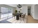 Stylish dining room featuring contemporary light fixtures, sleek furniture, and sliding door access to the backyard at 2671 Diamante Cir, Las Vegas, NV 89121