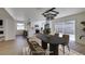 Well-lit dining area adjacent to a modern kitchen, featuring a sleek table and sliding glass doors to the backyard at 2671 Diamante Cir, Las Vegas, NV 89121