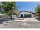 Charming single-story home featuring a gated front yard, desert landscaping and a spacious driveway leading to a two-car garage at 2671 Diamante Cir, Las Vegas, NV 89121
