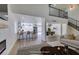 Open-concept living room seamlessly connects to the kitchen and dining area, complemented by a modern fireplace at 2671 Diamante Cir, Las Vegas, NV 89121