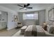 Calm main bedroom with a ceiling fan, neutral decor, and view into the on-suite bathroom at 2671 Diamante Cir, Las Vegas, NV 89121