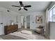 Comfortable main bedroom featuring a ceiling fan, dresser, and accent chair at 2671 Diamante Cir, Las Vegas, NV 89121