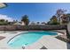Backyard view of the kidney-shaped swimming pool and spa with a rock perimeter at 2671 Diamante Cir, Las Vegas, NV 89121