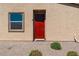 Charming front entrance with a red door, a window, and low-maintenance landscaping at 2685 Crystal Blue St, Laughlin, NV 89029