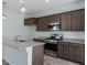 This kitchen has stainless steel appliances, granite countertops and an island at 2685 Crystal Blue St, Laughlin, NV 89029