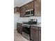 Kitchen featuring stainless steel appliances, granite countertops and brown cabinets at 2685 Crystal Blue St, Laughlin, NV 89029
