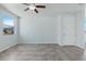 Bright and airy living room with tile flooring, ceiling fan, and large windows at 2685 Crystal Blue St, Laughlin, NV 89029