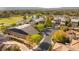 Expansive aerial shot of an estate showcasing lush landscaping, a pond, and multiple residential buildings at 3 Anthem Pointe Ct, Henderson, NV 89052