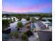 An aerial shot reveals a luxurious home near a lake, surrounded by lush landscaping and scenic views at 3 Anthem Pointe Ct, Henderson, NV 89052