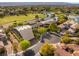 Stunning aerial view showcases an estate with a golf course, pond, and lush landscaping at 3 Anthem Pointe Ct, Henderson, NV 89052