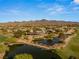 Expansive aerial shot of a luxury estate with a tranquil pond, golf course, and picturesque mountain views at 3 Anthem Pointe Ct, Henderson, NV 89052