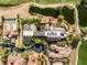 A bird's eye view of a sprawling estate with a pool, pond, and golf course amidst luxury homes at 3 Anthem Pointe Ct, Henderson, NV 89052