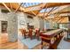 Open dining area with a stone wall, custom table and unique ceiling structure at 3 Anthem Pointe Ct, Henderson, NV 89052