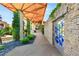 Elegant entryway featuring a stone wall, geometric stained glass, and lush greenery at 3 Anthem Pointe Ct, Henderson, NV 89052
