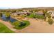 Lush landscaping surrounds this estate, featuring a serene pond and a manicured golf course in the background at 3 Anthem Pointe Ct, Henderson, NV 89052