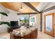 Modern living room boasts wood ceiling, stone wall, and serene outdoor views at 3 Anthem Pointe Ct, Henderson, NV 89052