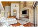 Bright main bedroom with hardwood floors, stone fireplace, high ceilings, and natural light at 3 Anthem Pointe Ct, Henderson, NV 89052
