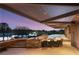Covered patio with a dining set near an infinity pool and views of the landscaped backyard at 3 Anthem Pointe Ct, Henderson, NV 89052