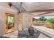 Covered patio with stone accents, overlooking a well-manicured backyard at 3 Anthem Pointe Ct, Henderson, NV 89052