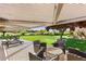 Relaxing covered patio with seating overlooking the backyard and garden at 3 Anthem Pointe Ct, Henderson, NV 89052