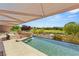 Inviting outdoor living area with a luxurious pool, rock feature, and serene golf course views at 3 Anthem Pointe Ct, Henderson, NV 89052