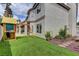 Spacious backyard with artificial turf, swing set, and lush landscaping, perfect for outdoor entertaining at 3005 Stern Dr, Las Vegas, NV 89117