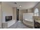 Luxurious bathroom featuring a separate shower and tub plus a fireplace at 3005 Stern Dr, Las Vegas, NV 89117