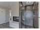 Luxurious bathroom featuring a large shower with gray tiling, a tub and a fireplace at 3005 Stern Dr, Las Vegas, NV 89117