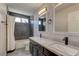 This bathroom features double sinks with dark cabinets, marble countertops, and a shower and tub combo at 3005 Stern Dr, Las Vegas, NV 89117