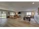 Open-concept living area with wood floors, fireplace, large sectional sofa, and access to backyard at 3005 Stern Dr, Las Vegas, NV 89117