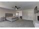 Spacious main bedroom featuring a ceiling fan, carpet and fireplace at 3005 Stern Dr, Las Vegas, NV 89117