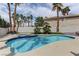 The serene backyard boasts a refreshing pool, spa, and lush landscaping for ultimate relaxation at 3005 Stern Dr, Las Vegas, NV 89117
