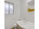 Bathroom featuring a modern sink, toilet, and a window providing natural light at 304 Orland St # 47, Las Vegas, NV 89107