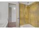 Well maintained bath features golden tile and white fixtures at 304 Orland St # 47, Las Vegas, NV 89107