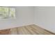 Bright bedroom featuring laminate flooring, neutral paint, and a large window at 304 Orland St # 47, Las Vegas, NV 89107