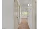 Hallway featuring multiple doors and carpet with view of window at end at 304 Orland St # 47, Las Vegas, NV 89107